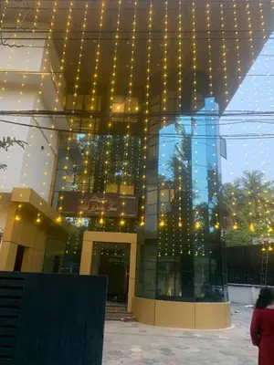 a building with a lot of lights on it at Adi Deva Inn in Guruvāyūr