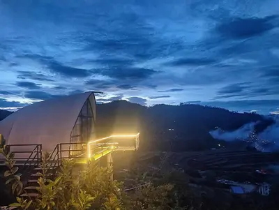 a view of a building at night with the sky at Cocoon Creek in Kodaikānāl