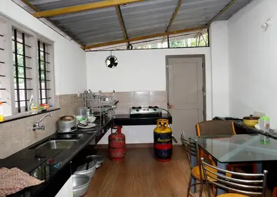 a kitchen with a sink and a counter top at Natura Homestay in Padinjarathara
