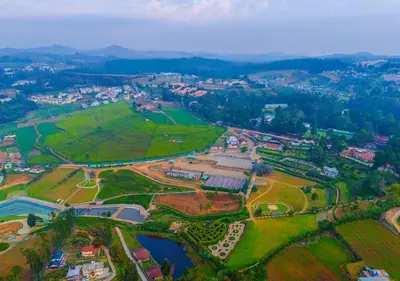 an aerial view of a park with a city at Mowbray House Resort Ooty by VOYE HOMES in Ooty