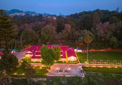 an aerial view of a house with a red roof at Mowbray House Resort Ooty by VOYE HOMES in Ooty