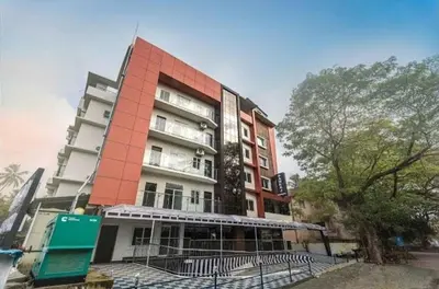 a tall building with a fence in front of it at Guruvayoor Suits Pankaj Suits in Trichūr