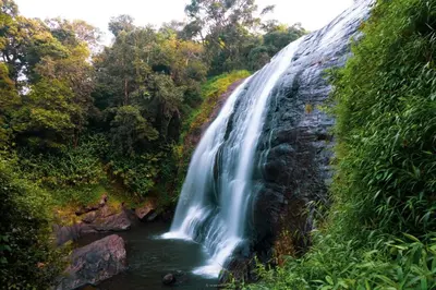 a waterfall in the middle of a river at Coorgglade in Kakkabe