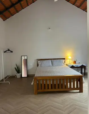 a bedroom with a large bed in a room at Airy haven in Kushālnagar