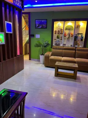 a living room with a couch and a table at Sunset View Inn in Irinjālakuda