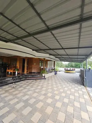 an empty building with a large ceiling and a large patio at Sunset View Inn in Irinjālakuda
