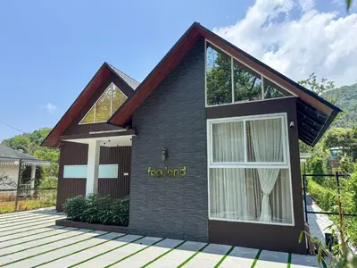a house with the words new end written on it at Fog Land Pool Villa by BMT in Vythiri