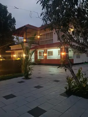 a house with a parking lot in front of it at Royal Heaven in Ambalavayal