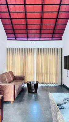 a living room with a couch and a red ceiling at Royal Heaven in Ambalavayal