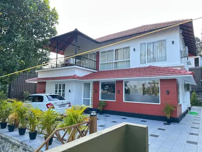 a house with a car parked in front of it at Royal Heaven in Ambalavayal