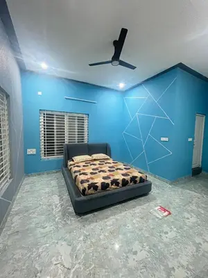a blue bedroom with a bed and a ceiling fan at Chamundi Temple-Hill View in Mysore