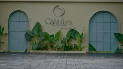 a building with three windows and a sign on it at Tangerine Tales Boutique Resort By LexStays in Wayanad