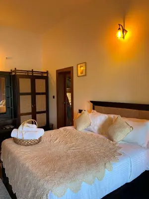 a bedroom with a bed with a basket on it at Tangerine Tales Boutique Resort By LexStays in Wayanad