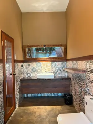 a bathroom with a sink and a mirror on the wall at Tangerine Tales Boutique Resort By LexStays in Wayanad