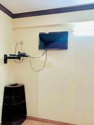 a flat screen tv hanging on a wall at Hotel Alsaj in Alwaye