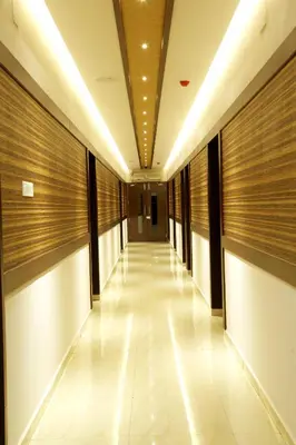 a hallway in a building with wooden walls at Rydges Inn in Kottakkal
