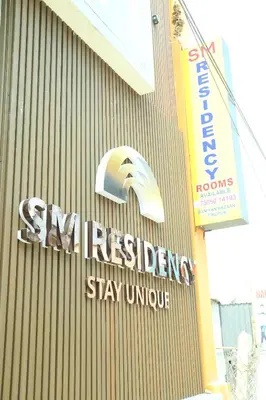 a sign on the side of a building at S M Residency in Tiruppūr