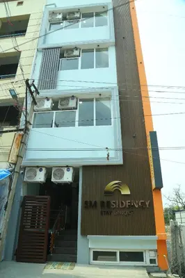a building with a sign on the front of it at S M Residency in Tiruppūr