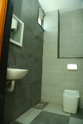 a bathroom with a sink and a toilet at S M Residency in Tiruppūr