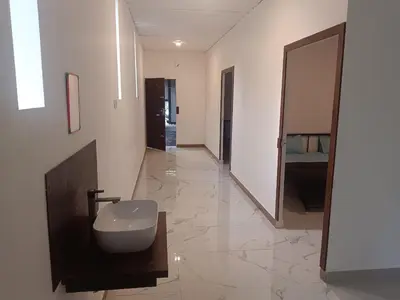 a bathroom with a sink and a large mirror at Riverside inn in Wayanad
