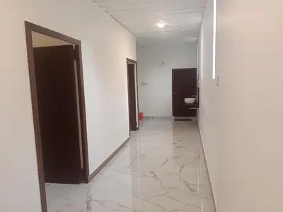 an empty hallway with a toilet in a building at Riverside inn in Wayanad