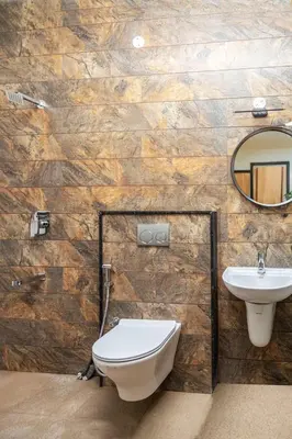 a bathroom with a toilet and a sink at May Flower Cottage in Ooty