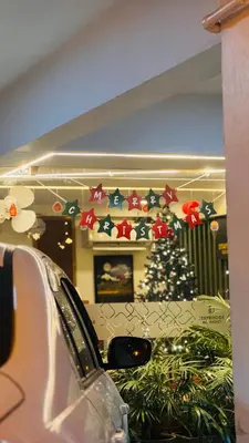 a christmas tree in the corner of a room at Stay Bridge Residency in Kozhikode