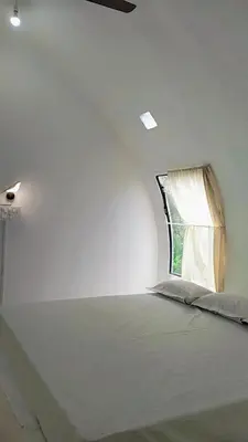 a bed in a room with a window at Mamalakandam - Egg House - in Diya Homestay in Mamalakandam