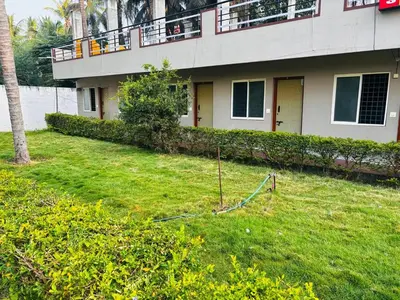 a house with a lawn in front of it at Yash Residency in Mysore