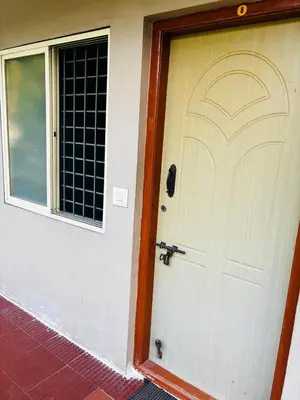 a door to a house with a window at Yash Residency in Mysore