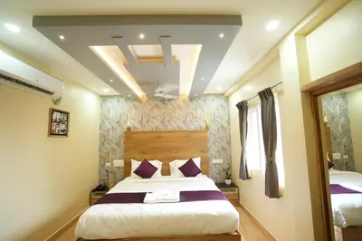 a bedroom with a large bed with purple pillows at M M Hotel Royal Respite in Coimbatore