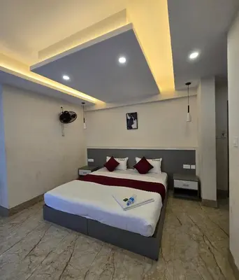a bedroom with a large bed in a room at Redbell Suites Civil in Kozhikode