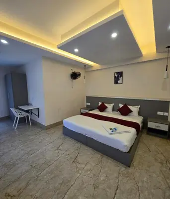 a bedroom with a large bed in a room at Redbell Suites Civil in Kozhikode