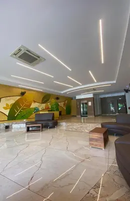 a lobby with couches and a painting on the wall at Pumpkin Tower in Malappuram