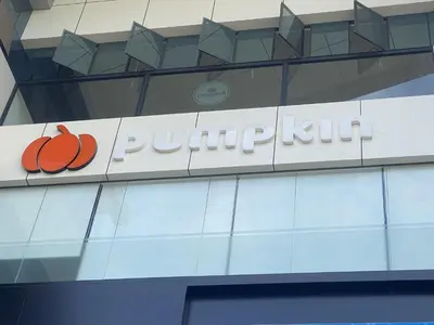 a sign on the side of a building with a pumpkin sign at Pumpkin Tower in Malappuram