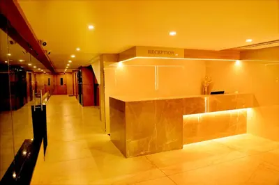 a lobby with a reception desk in a building at Hotel Le Palace in Coimbatore