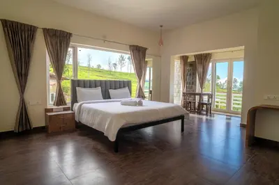 a bedroom with a bed and a large window at The Misty Meadows in Coonoor