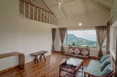 a living room with a couch and a table at The Misty Meadows in Coonoor
