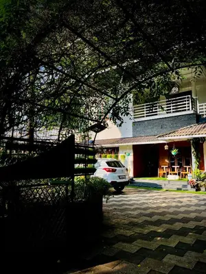 a white car parked in front of a building at JoeVilla Homestay Near Kottiyoor in Kelakam