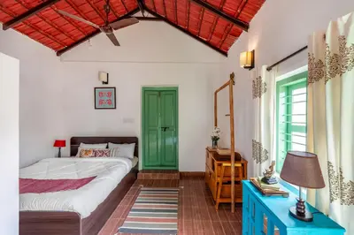 a bedroom with a bed and a green door at Sliceinn Somewhere Together In Biligeri in Madikeri