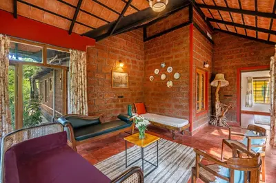 a living room with a brick wall at Sliceinn Somewhere Together In Biligeri in Madikeri