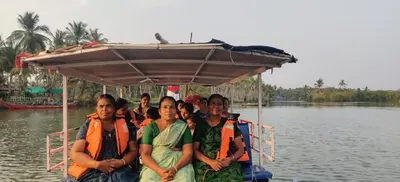 a group of people sitting in a boat on the water at Kadingis homestay and eco tourism in Kadalundi
