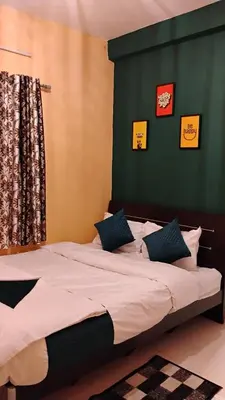 a bedroom with a large bed with a green wall at Retro Radiance in Ooty
