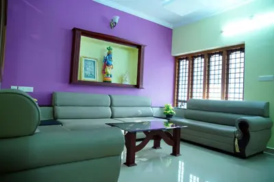 a living room with a couch and a table at Sree Nandhavanam Homestay in Guruvāyūr