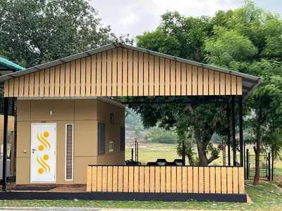 a small building with a large door and a porch at Ibex Resorts, Malampuzha - Kava Eco Camp and Caravan Park in Palakkad