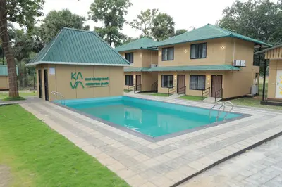 a house with a swimming pool in front of a house at Ibex Resorts, Malampuzha - Kava Eco Camp and Caravan Park in Palakkad