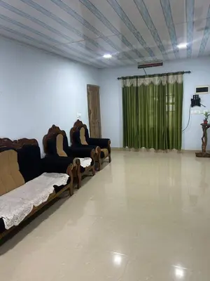 a room with three beds and a green curtain at Rifa homestay in Kalpetta