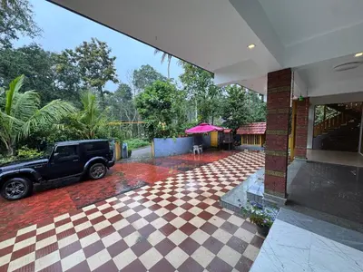 a black truck parked outside of a house at Sukhavana home stay suite in Madikeri