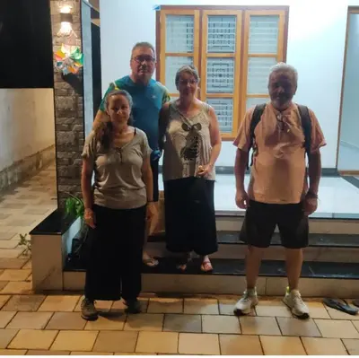 a group of three people standing on steps at Peaceful Homestay near Kizhunna Beach in Thottada