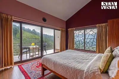 a bedroom with a bed and a large window at StayVista at Ambrosia access to water stream in Kotagiri
